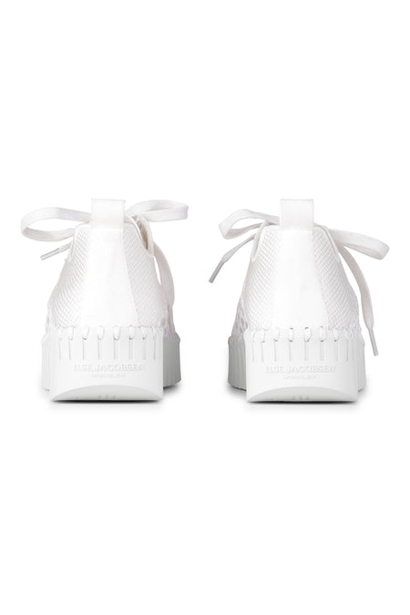 | White; White sneakers with textured sole on a white background